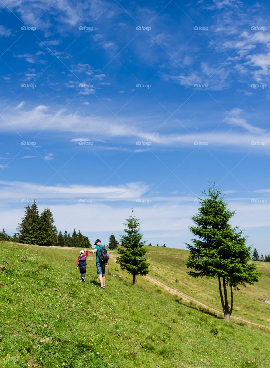 father and son walking in the Carpathian Mountains