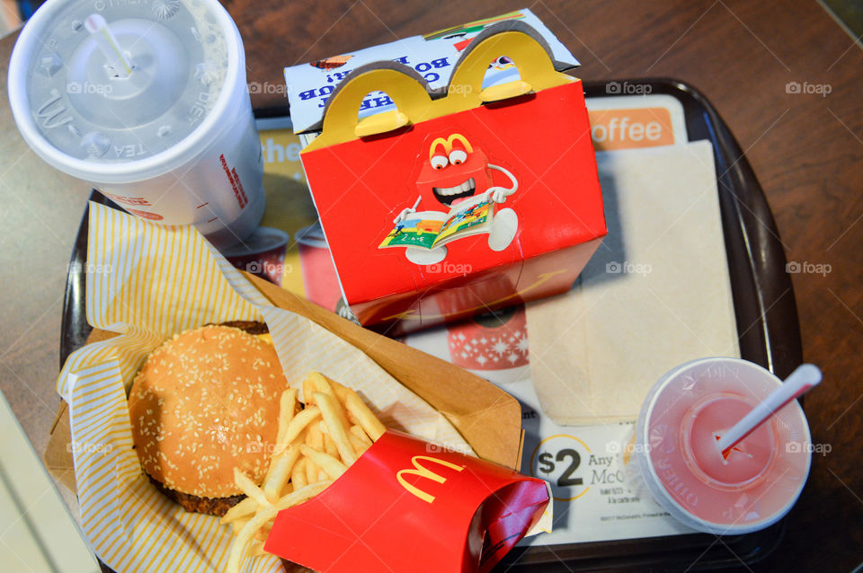 Flat lay of a McDonald's combo meal and a happy meal sitting on a tray at a McDonald's restaurant