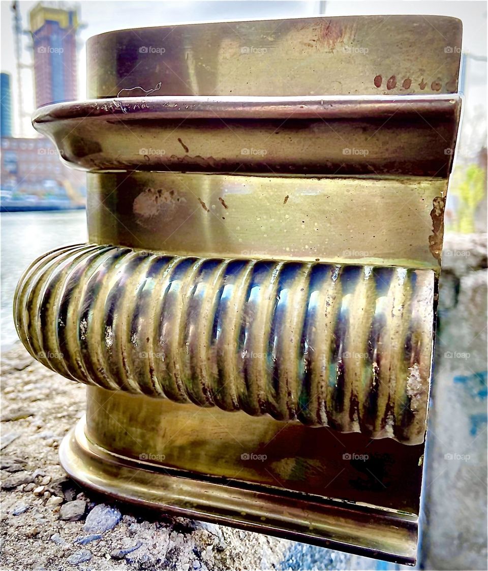 Another closeup on the elegant details of the rare bronze fireplace fender in a style from bygone eras fit to be amongst the furnishings of a castle or elegant estate. 2022. Hypnotic Productions