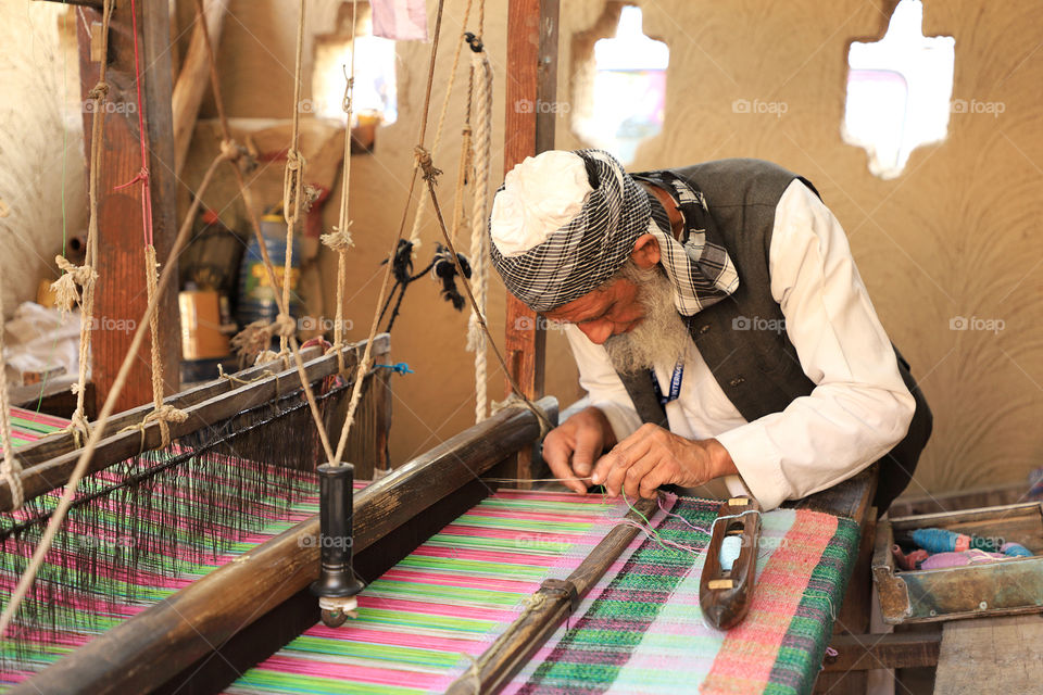 A traditional Indian carpet weaver