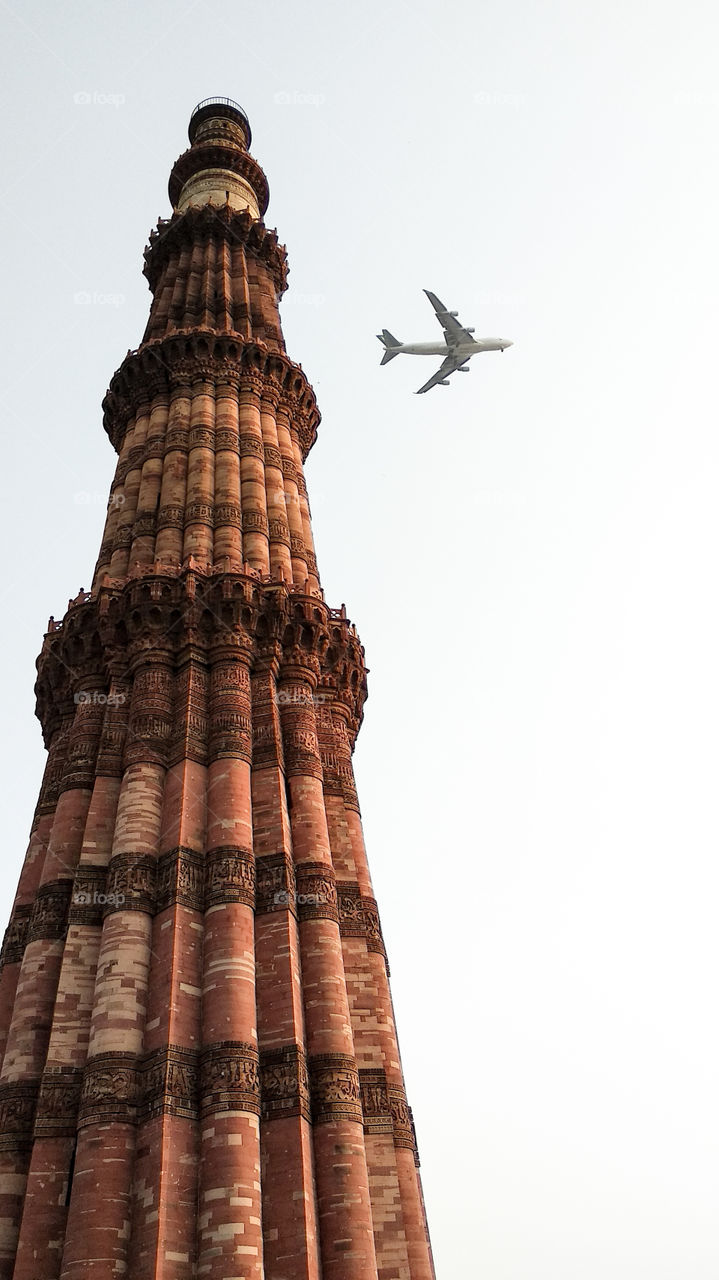 Beautyful kutub minar veiw with passing plane..