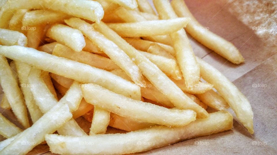 Crispy potato fries, ready for consumption. Golden brown perfection.