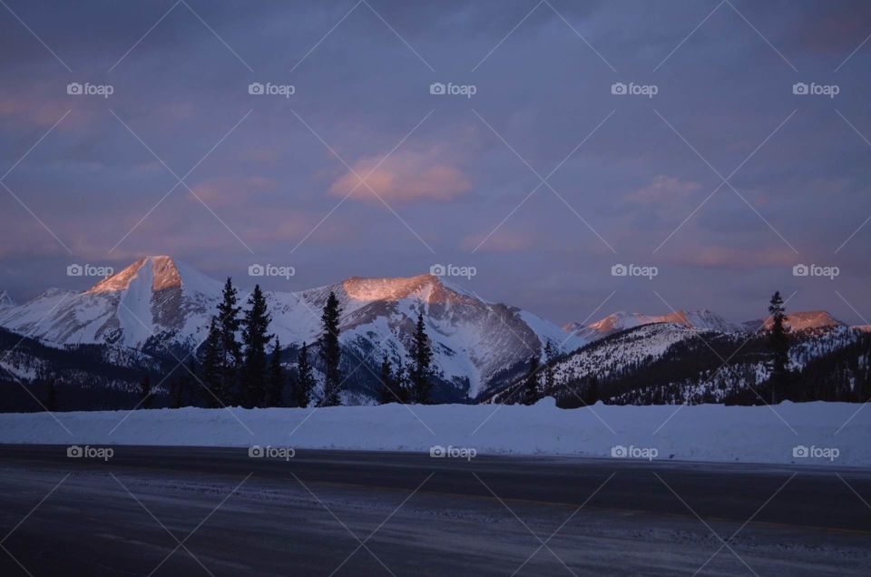 The last bit of light creating a stunning pink and purple sunset over the tall Rocky Mountain peaks on Monarch Pass, Colorado