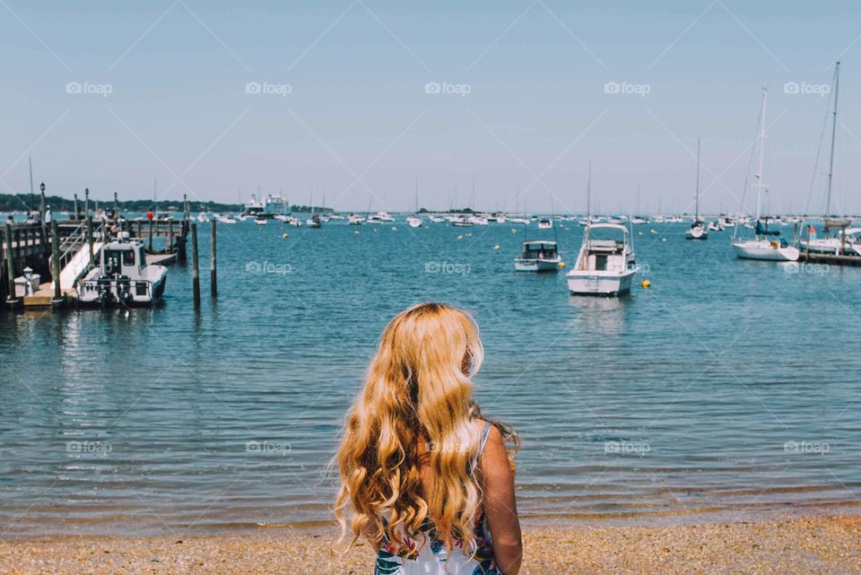 Blonde standing by the water at the beach