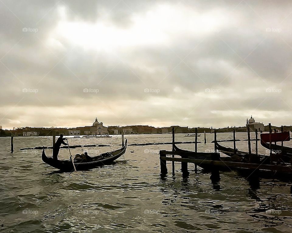 A gondolier steers his gondola near San Marco in Venice, Italy