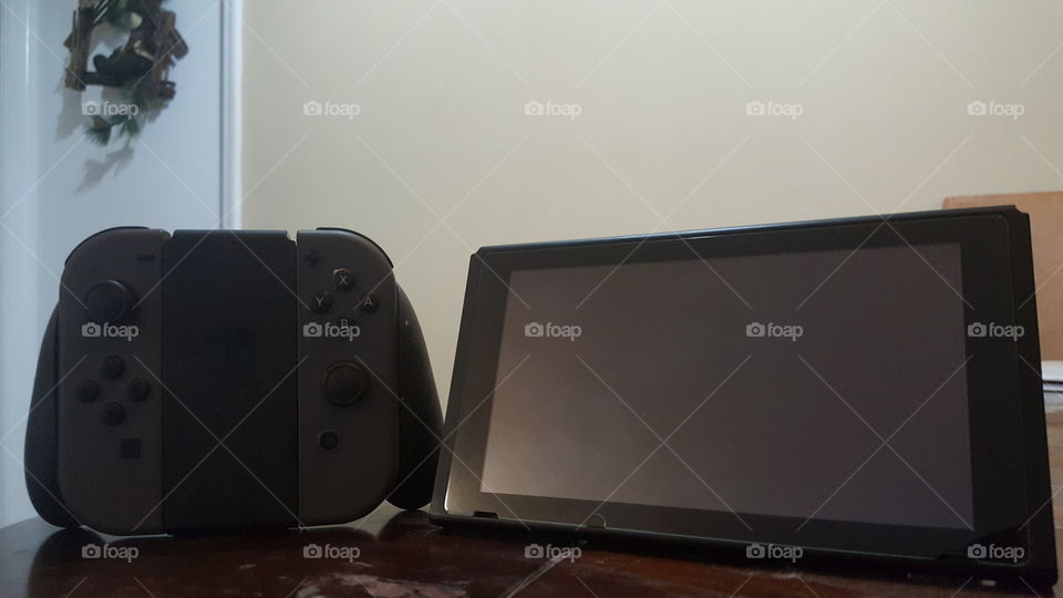 A Nintendo Switch with gray Joycons in the home.