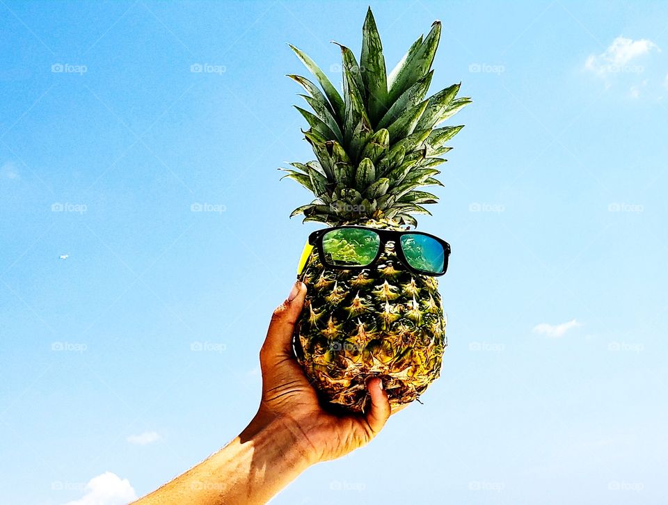 cool pineapple flying high in sky.