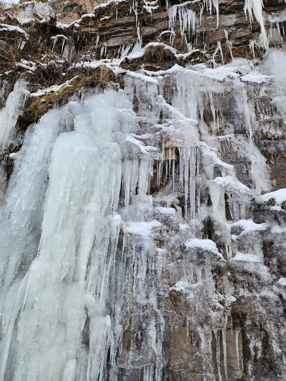 A waterfall freezes into an icy cascade during a cold wintery snap in New England