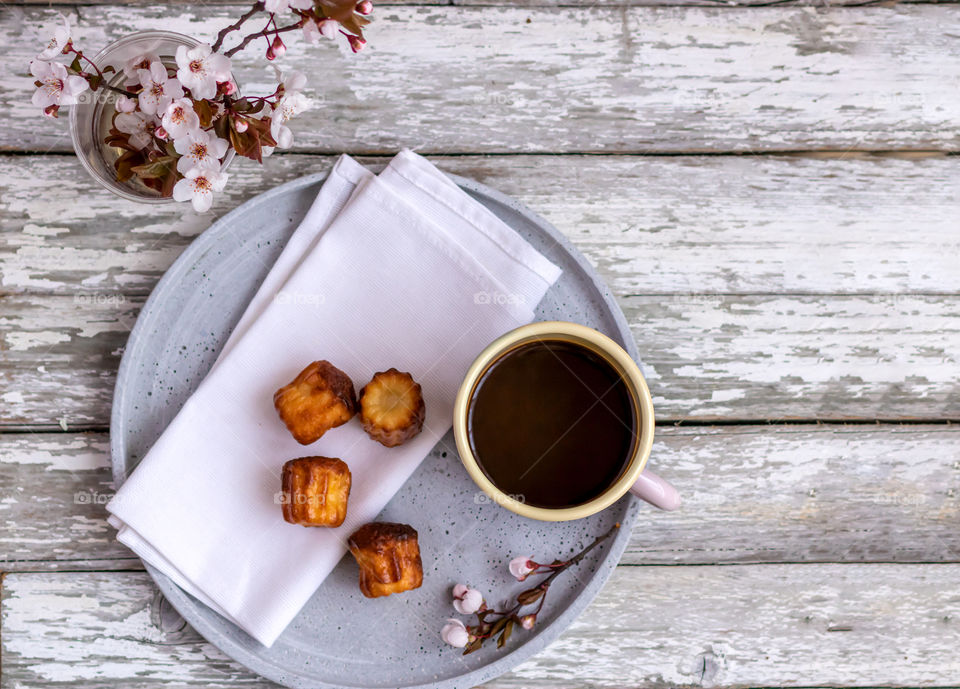 Top view to mug with coffee and some pastry.