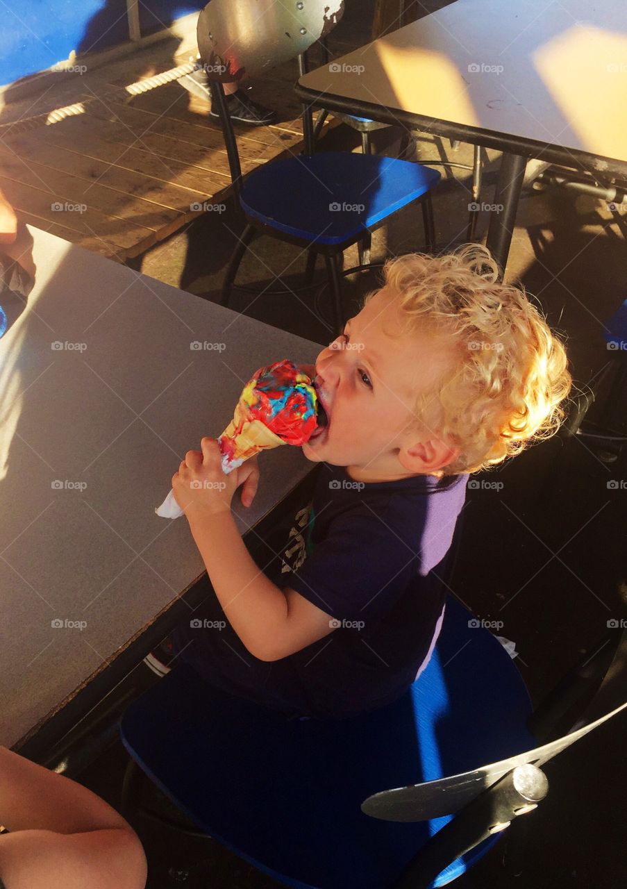 Toddler eating ice cream cone 