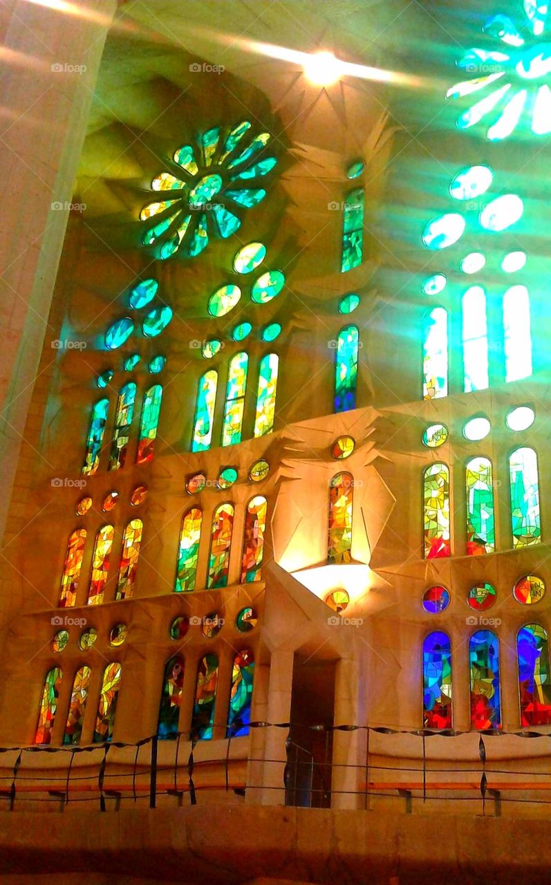 Color clash: sunlight shines in through stained glass windows of La Sagrada Familia cathedral.