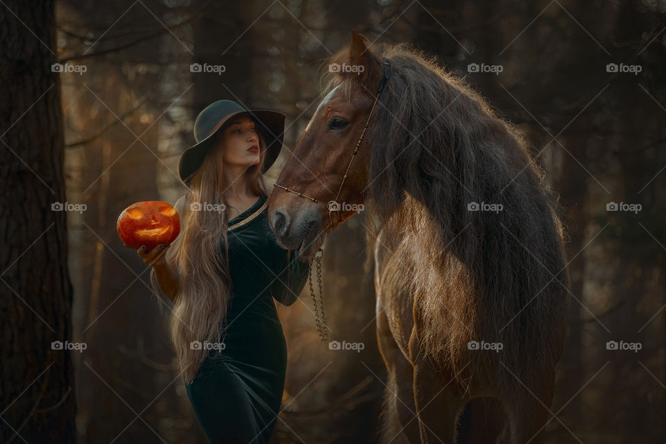 Beautiful woman portrait with horse. Halloween theme