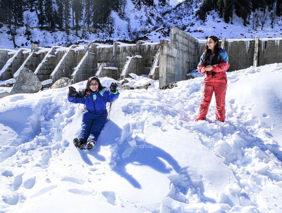 Womens enjoying in winter snowfall