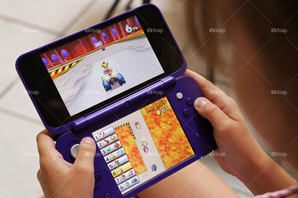 Child playing Mario Cart on the Nintendo DS