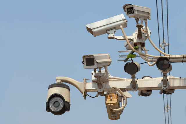 Security camera hanging on sky
