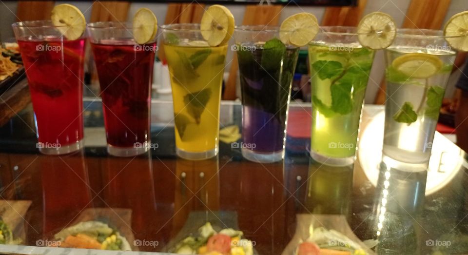 Fresh juice with lemon different colours clousup photo