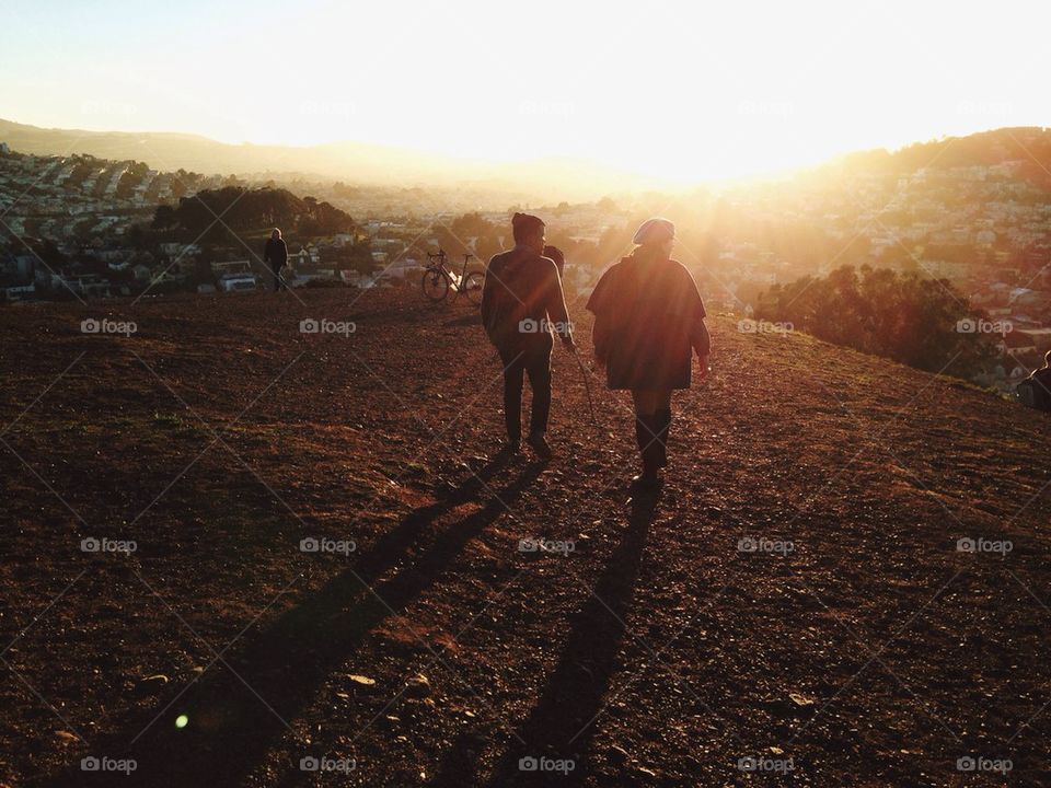 Couple walking into sunset