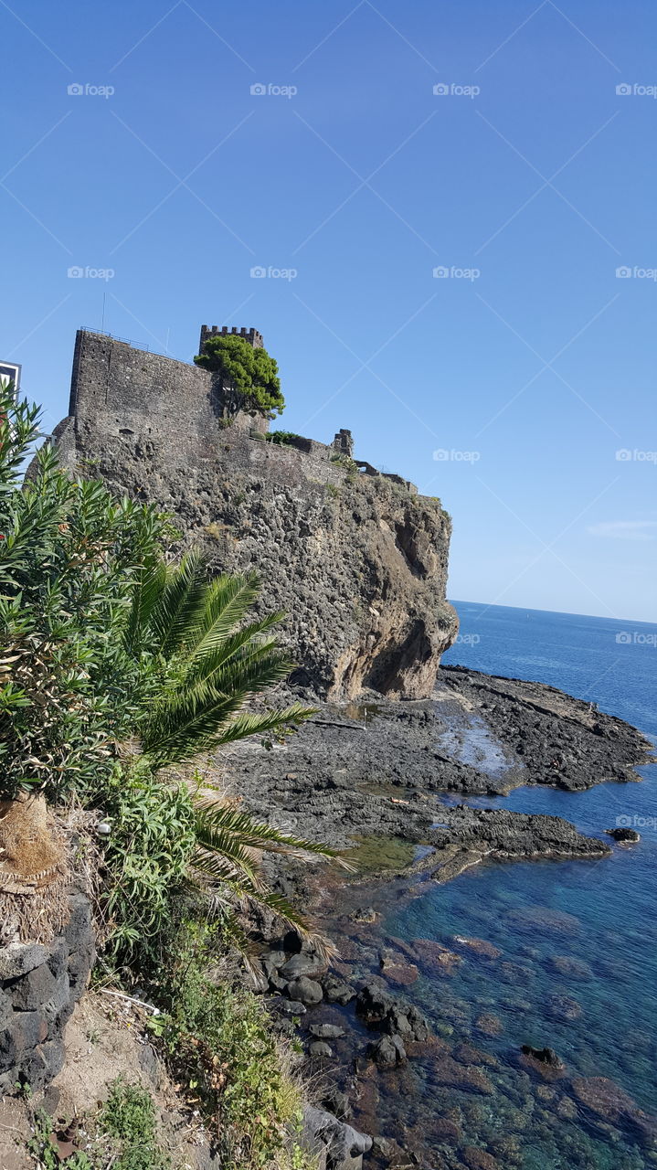castle on a mountain overlooking  Giardini Naxos beach