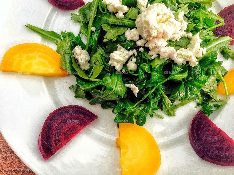 Elevated view of spinach salad with cheese