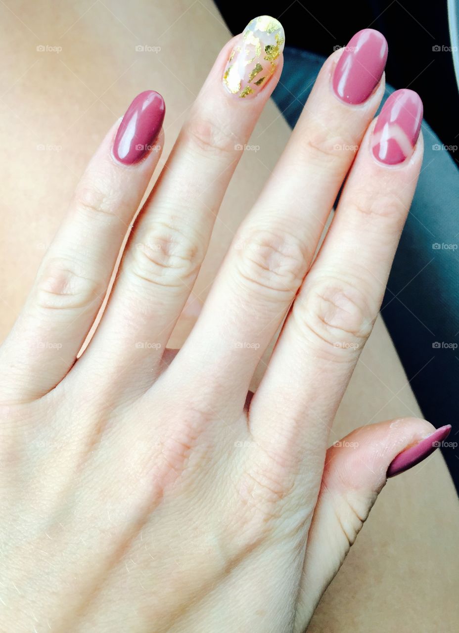 Dusty rose coloured nails with specks of gold. Detailed ring and pointer fingers. 