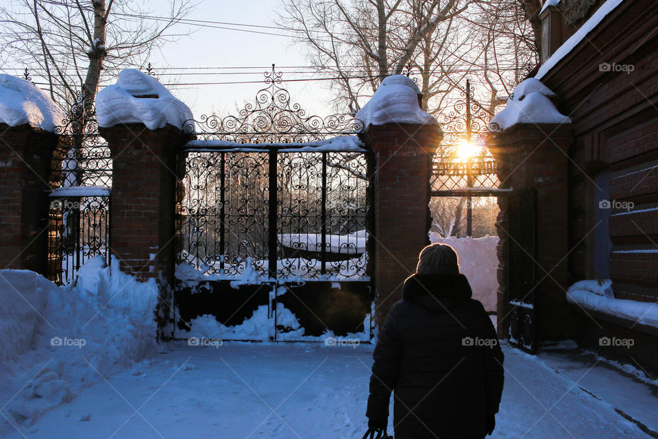 sunset,gate and woman from the back