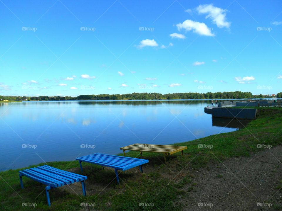 landscape lake shore and people fisherman blue sky background, summer time, beautiful nature