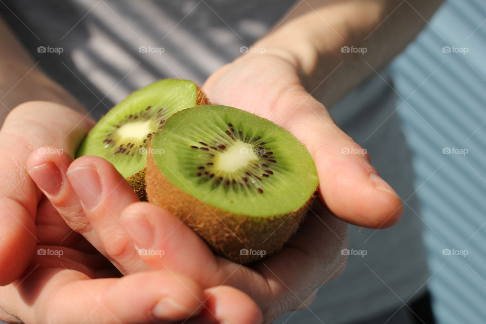 Hands, female hands, kiwi in hands, kiwi fruit, still life, abstraction