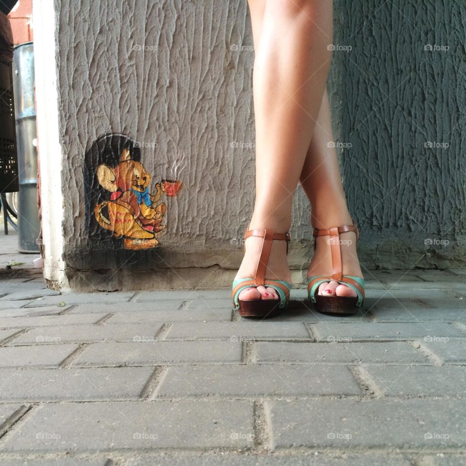 legs next to a small street art 