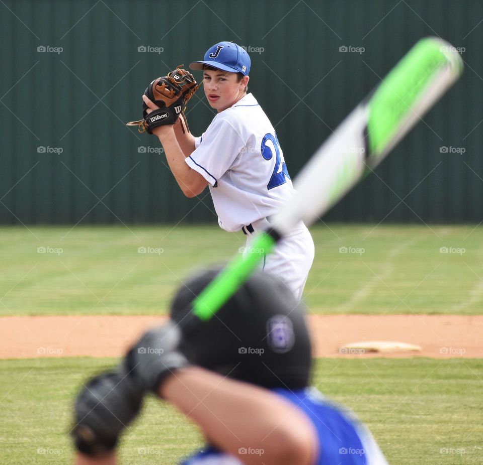 Player preparing to throw baseball to batter