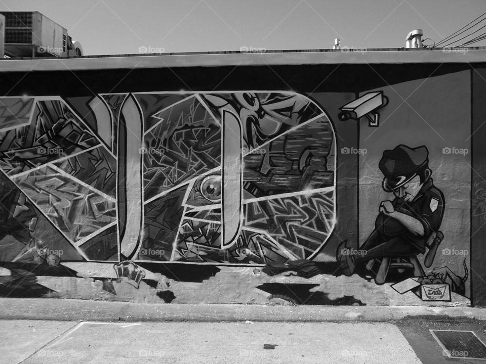 Black and white policeman. Driving through the alley