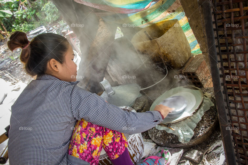 Rice papers being prepared on the side of the road in Cambodia 