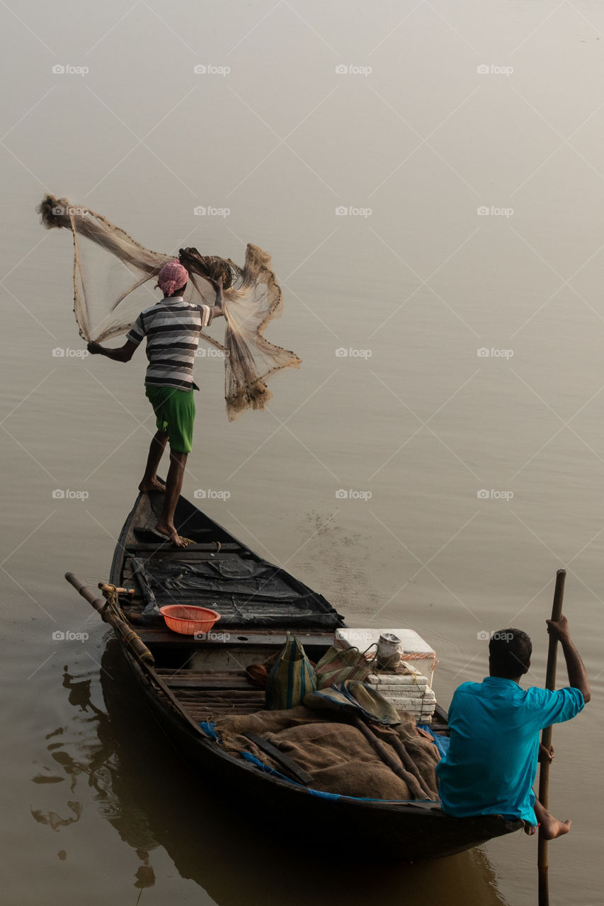 Fishermen is fishing with net.