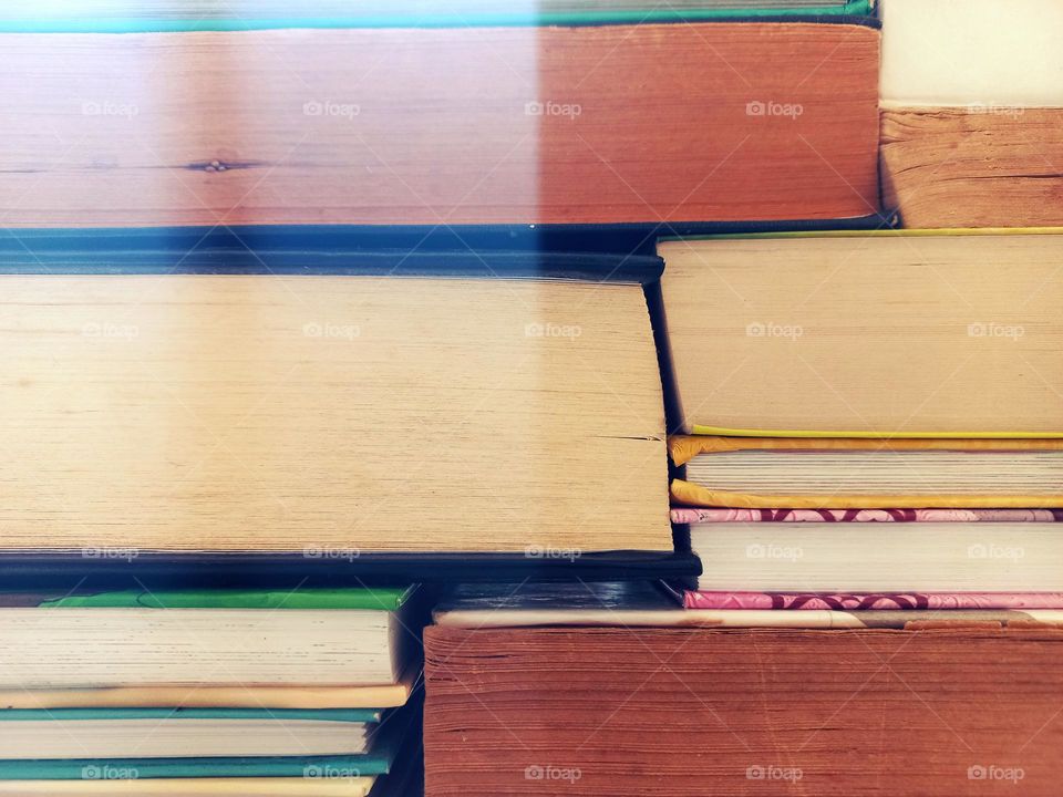 stacked books resemble rectangular brick building.