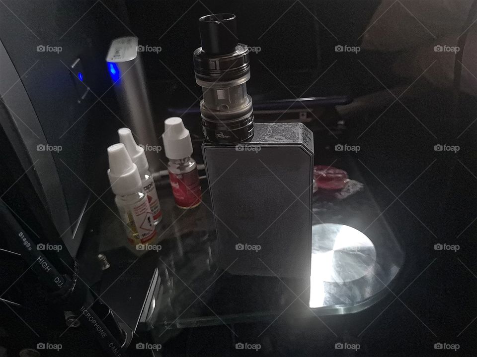 vape on a table with other random stuff