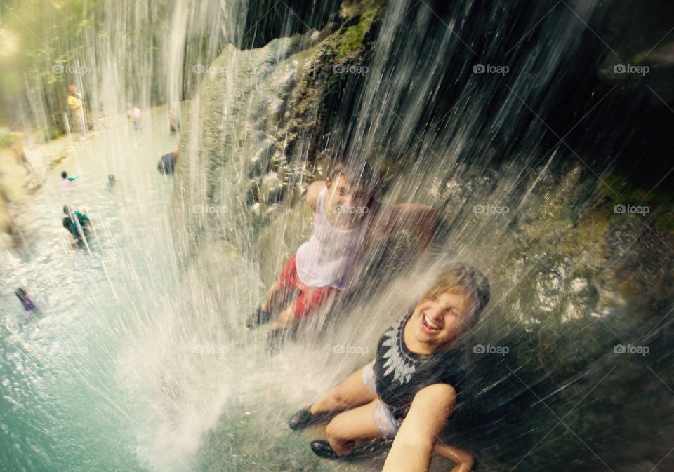 Children playing in waterfall