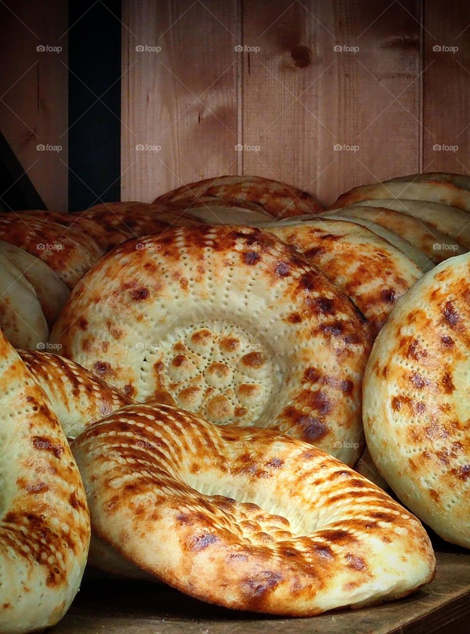 Food.  Bread.  Ready hot pita breads lie on the shelf