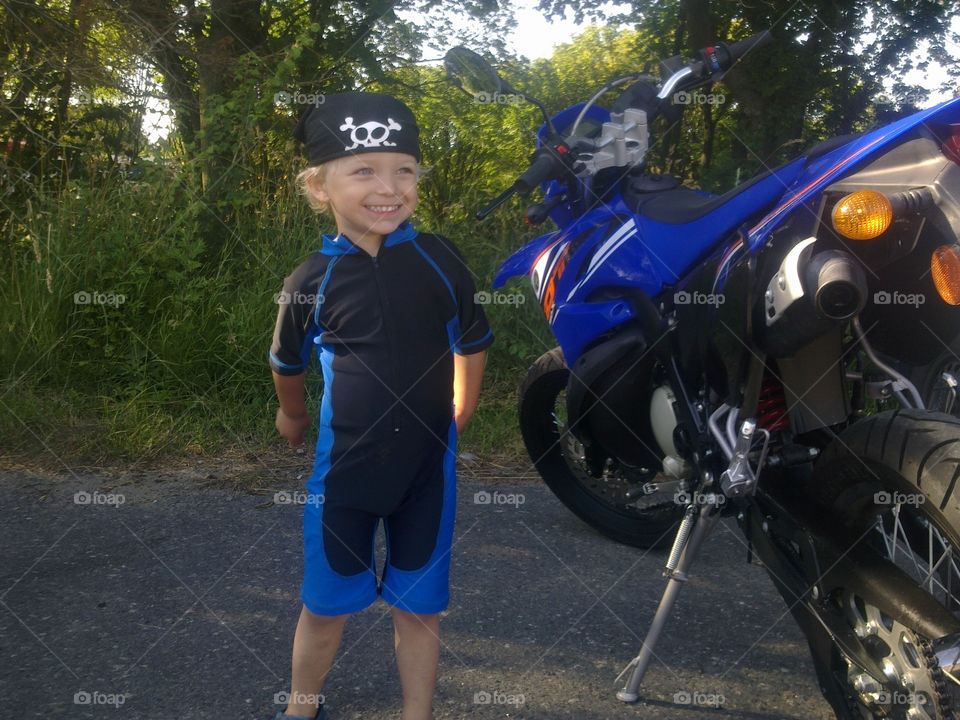 beautiful cool boy stand by motorbike