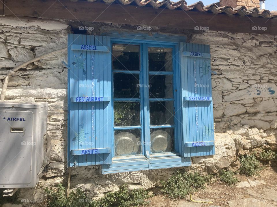 Greek village in Turkey. Blue sky and tall palm trees. Sunsets and sunny days. Summertime in Kusadasi. Vacation travel in Turkey . Summer view. Sunny day during vacation 