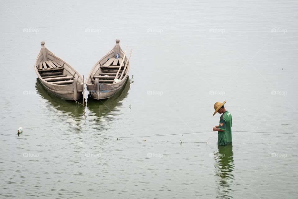 Fishermen at the longest U-Bein wooden bridge in MDL Myanmar