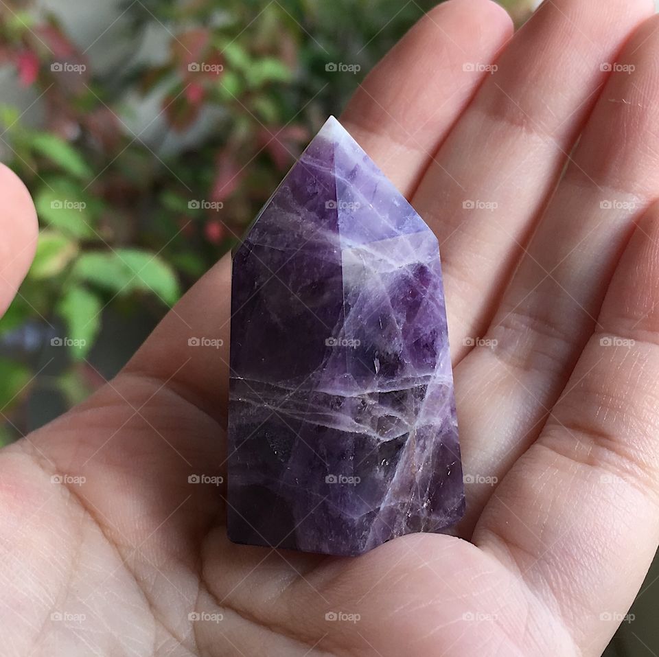 A small purple chevron amethyst crystal point.