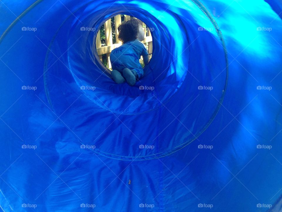 Baby tunnel. Baby in a pop-open tent tunnel.