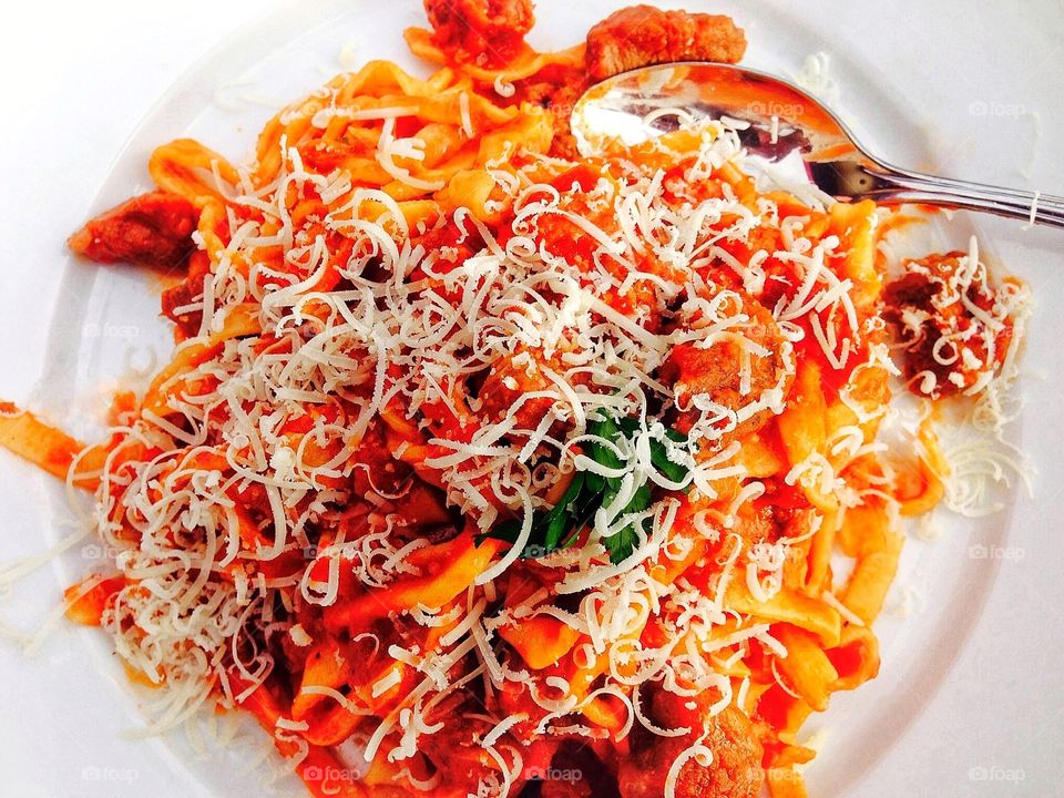 Tagliatelle pasta noodles in red sauce with pecorino cheese