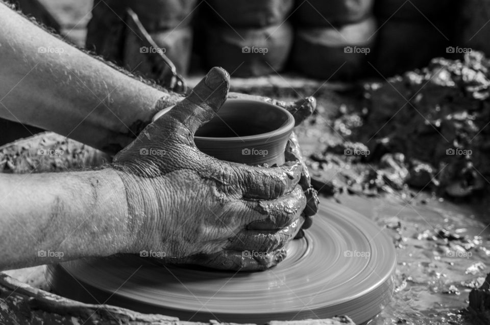 Potter hands working with clay