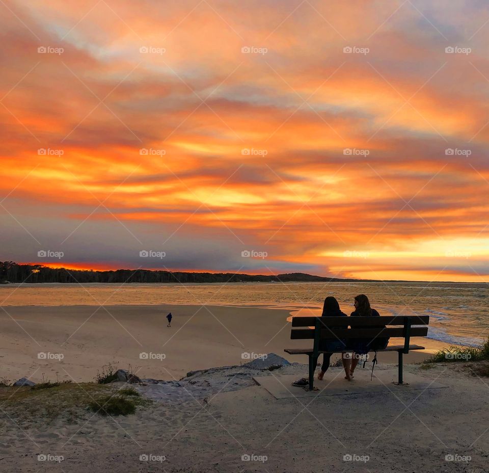 Watching the sunset at the beach river mouth