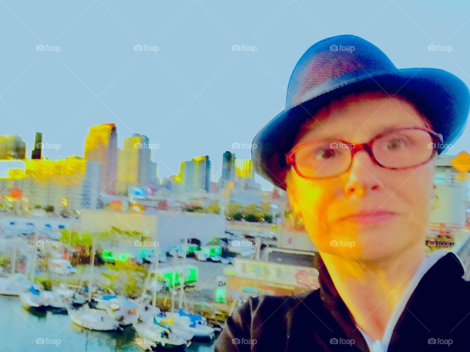 Petra Schiller photographed against a backdrop of the Long Island City, Queens, New York City skyline at the „golden hour“ of sunset and of upcoming nightfall. Photo from 2019. Hypnotic Productions