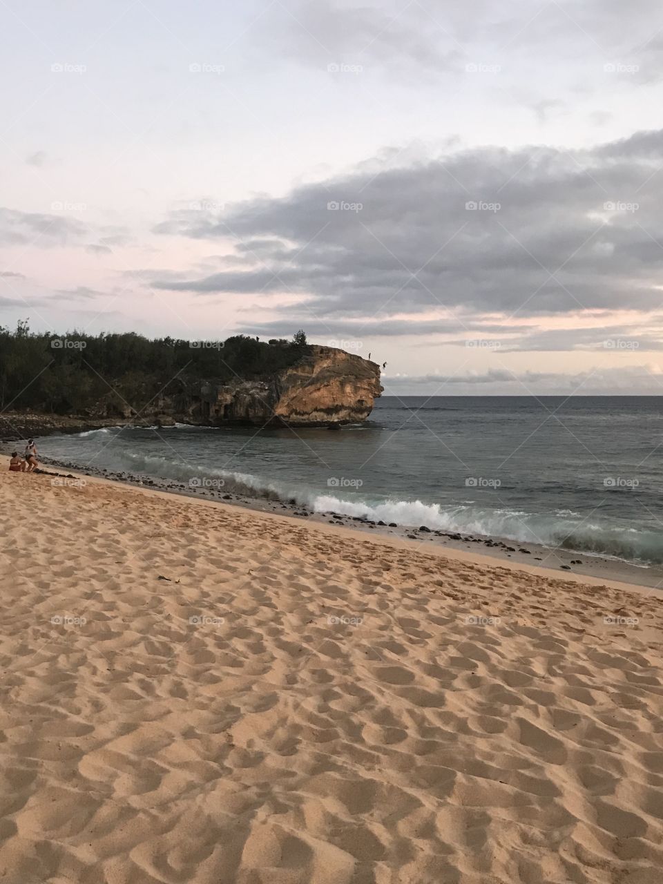 Cliff diving at dusk Poipu Beach
