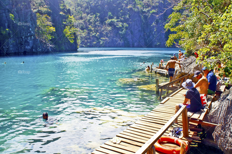 People having fun, swimming at Kayangan Lake, Coron Islands, Palawan, Philippines