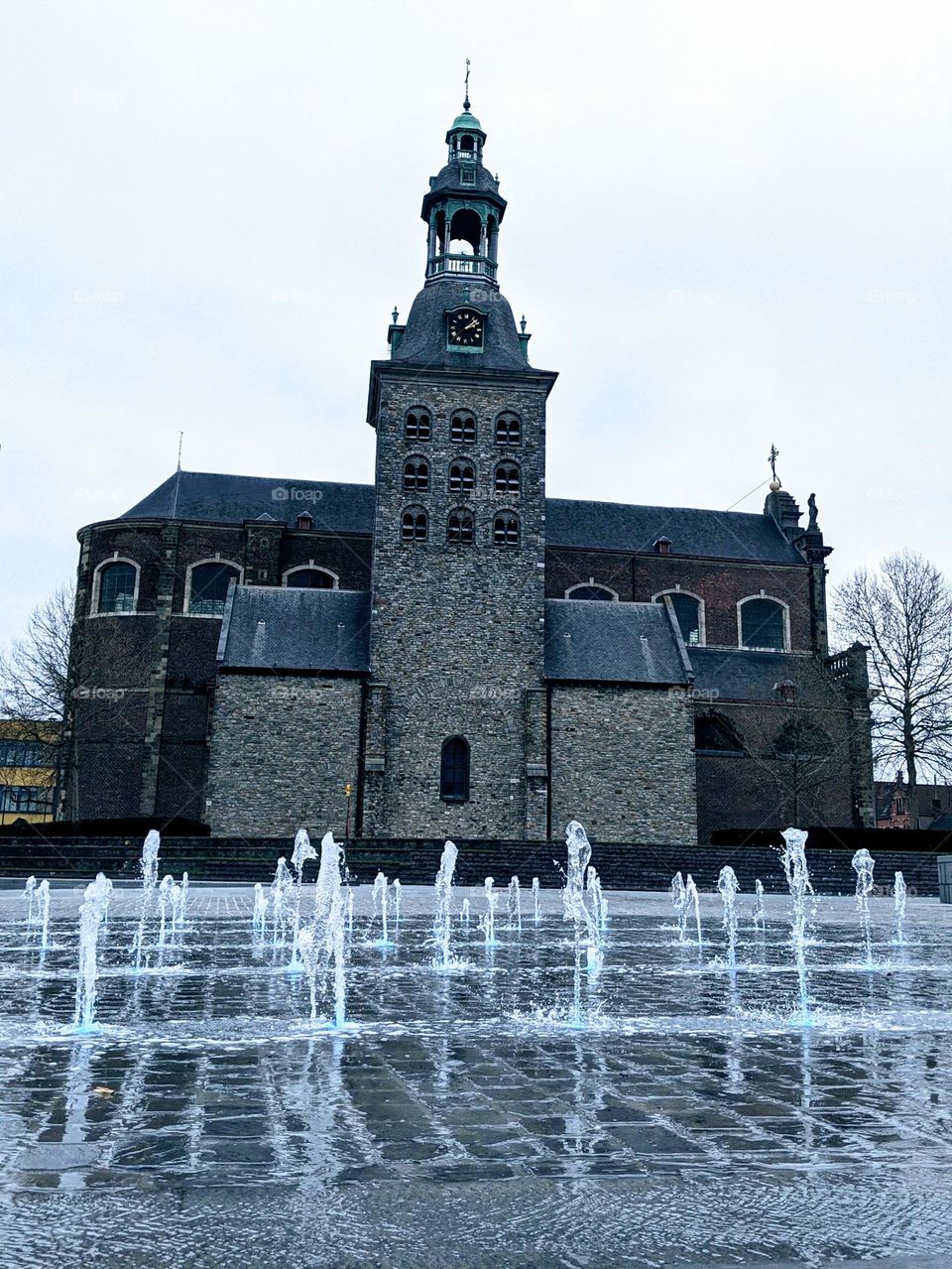 Water fountain on a public square in front of a church
