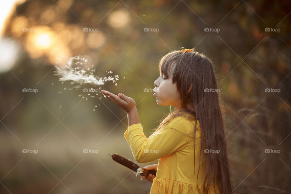 Little girl in yellow dress outdoor portrait 