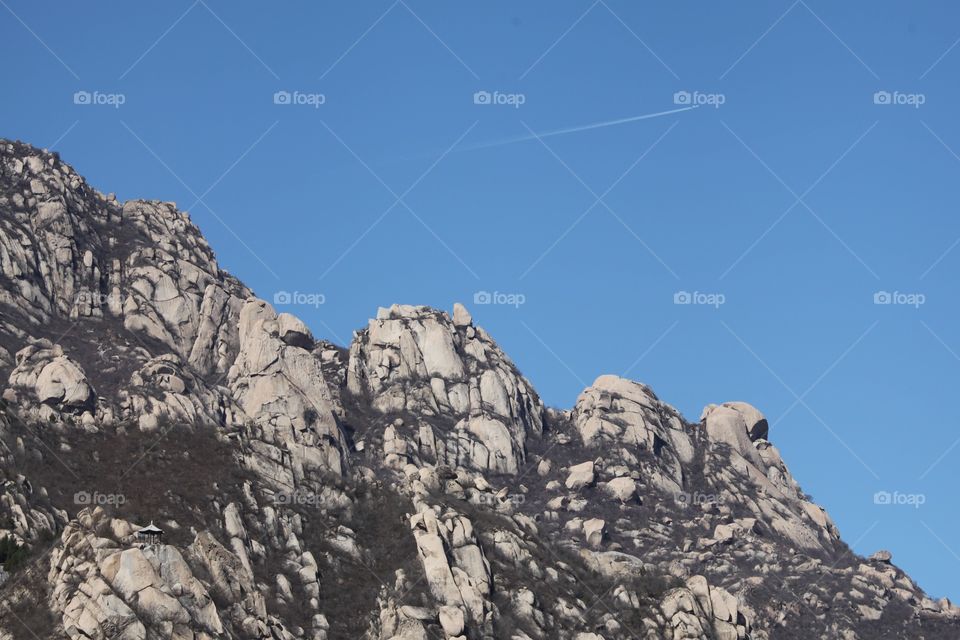 Low angle view of mountain range against clear sky